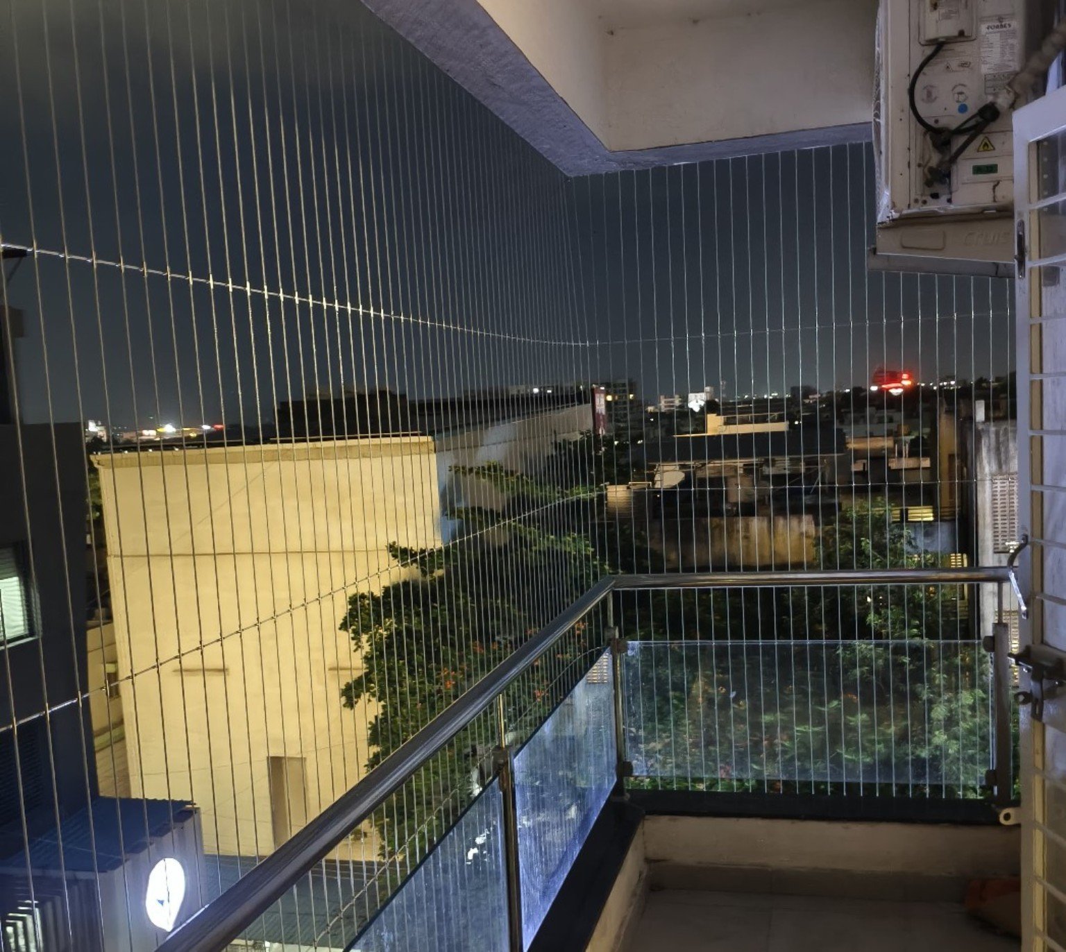 Invisible grill installation on a Hyderabad apartment balcony